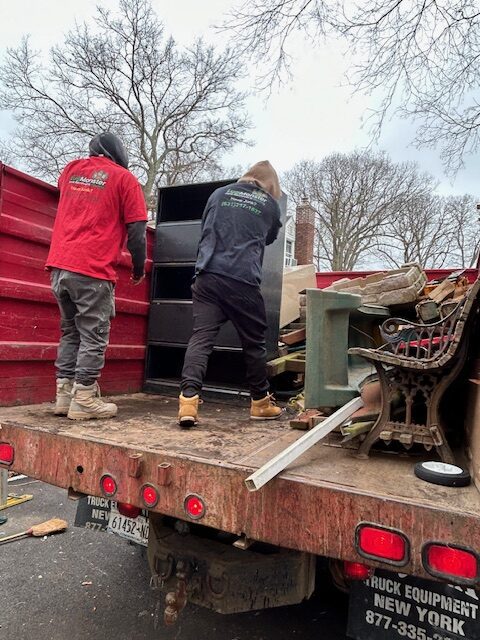 LugMonster team loading junk into truck during removal service in Long Island.