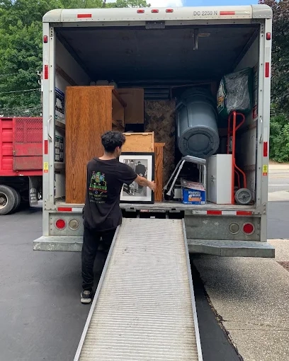 Furniture and junk removal in Long Island NY with professional junk removers loading a moving truck