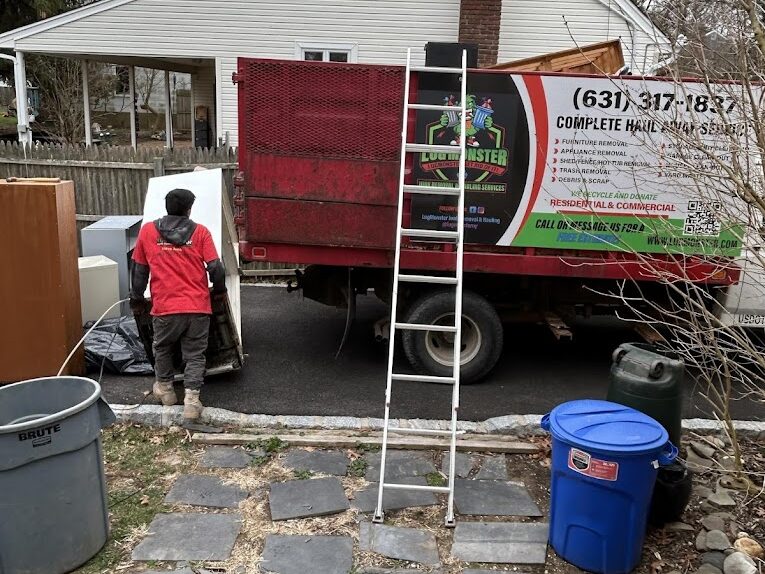 LugMonster junk removal truck in Long Island with worker loading items for haul-away service.